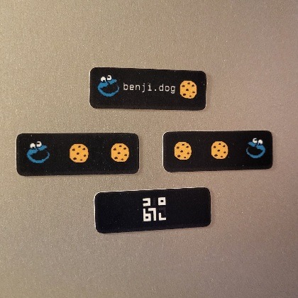 4 stickers showing different frames of my 88x31 image. There is cookie monster with the text benji.dog, cookie monster eating cookies like pacman in both directions, and the favicon for this site which says benji in elian script